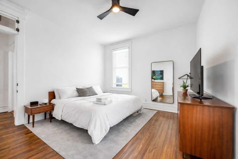 Bedroom 1: Spacious bedroom featuring a luxurious king-sized bed and a smart TV, perfect for relaxation and entertainment.