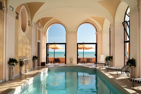 Indoor pool, pool umbrellas, sun loungers