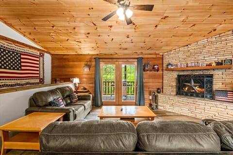 Gather around the stone fireplace as the flames flicker and the room glows. Comfortable seating, a rustic mantel, and cabin character create the perfect spot to unwind after a day of exploring.