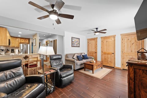 Unwind in your spacious living area with cozy seating, rustic wood accents, and an open layout perfect for relaxation after mountain adventures.
