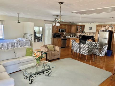 Upstairs of house with kitchen full bar and dining space. Also a queen bed