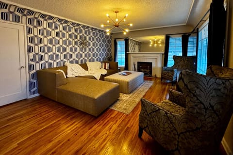 Art Deco-inspired comfortable and luxurious living room with large TV and expansive sectional.