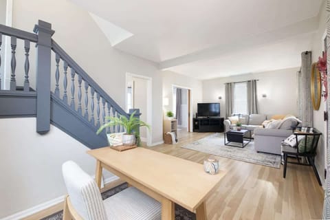 Open living area w/ dining table, staircase & airy layout for easy flow