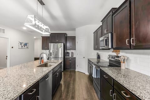 Spacious kitchen with granite countertops and breakfast bar seating