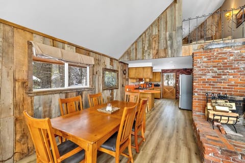 Rustic home with a cozy dining area, open-concept kitchen, and vaulted ceiling.
