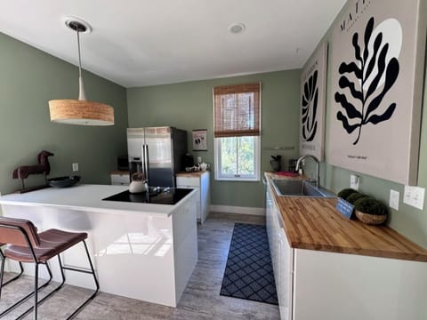 Fully stocked kitchen with range, microwave, dishwasher, coffeemaker, & fridge.