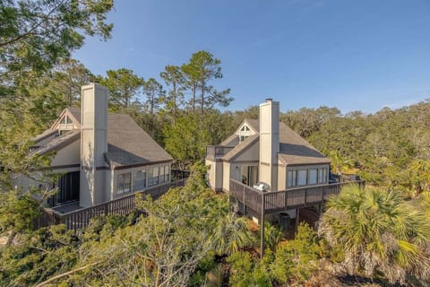 Aerial view of property surrounded by lush trees