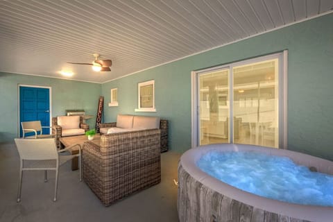 Enjoy the perfect outdoor escape on the back deck, with seating for lounging and a hot tub for ultimate comfort and relaxation.