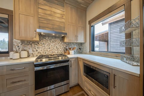 The chic, open kitchen offers ample space & all the comforts of home