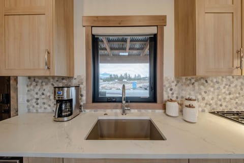 The chic, open kitchen offers ample space & all the comforts of home