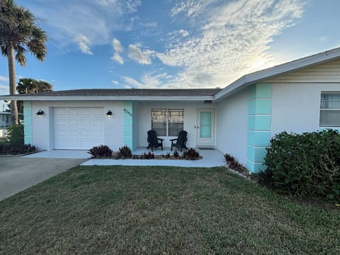 Front of house.  Two Adirondack chairs to enjoy your morning coffee