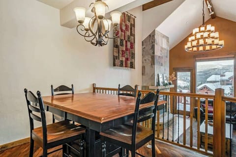Gather around with a view—this elevated dining space overlooks the cozy living room and beatiful scenery.