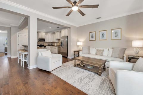 Bright living room with hardwood floors and ceiling fan