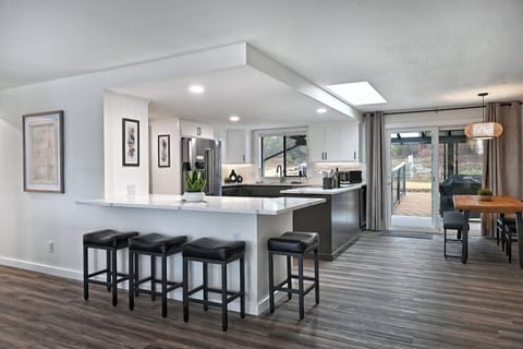Modern open kitchen and dining area with sleek finishes, ample seating, and access to the outdoor patio for a seamless dining experience