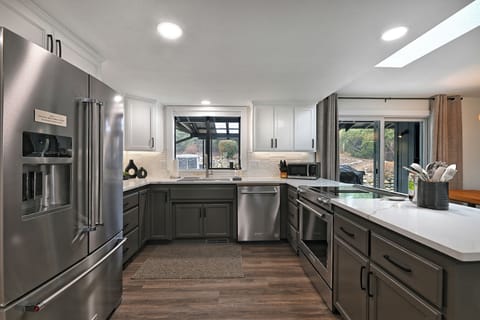 Stainless steel appliances, sleek cabinetry, and ample countertop space.
