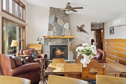 The dining area offers a perfect spot for meals, while an additional seating area with a charming fireplace creates a cozy nook to unwind and enjoy the warmth.