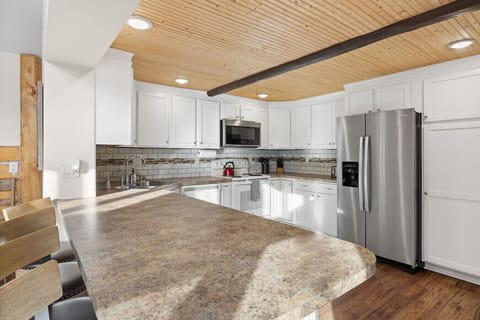 The kitchen is fully equipped with a double-door refrigerator, oven, microwave, dishwasher, and many more essentials, making it perfect for preparing and enjoying meals with ease.