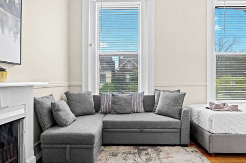Bedroom 4: The corner couch adds a touch of personality to this stylish bedroom.