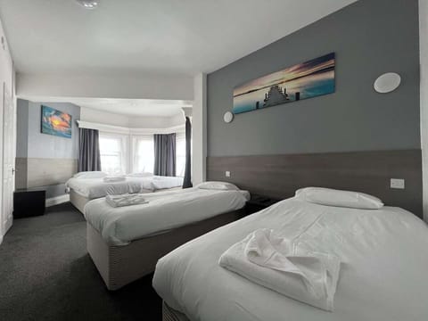 Deluxe Quadruple Room, City View | Blackout drapes, iron/ironing board, free WiFi