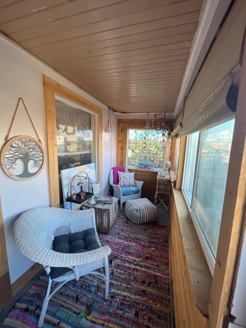 Darling enclosed front porch, perfect hang spot.