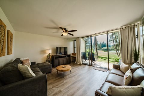 Sunlit living room opening to greenery for easy lounging & slow mornings