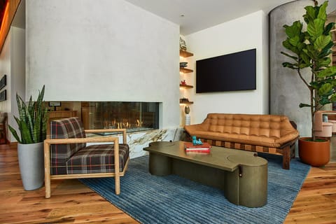 Cozy up by the fireplace in this beautifully designed space, where warm tones, plush seating, and soft lighting create the ultimate ambiance for relaxation and conversation.