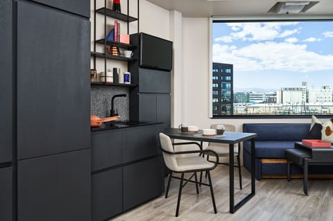 A workspace with city views, seamlessly blending modern aesthetics with functionality for both work and relaxation.