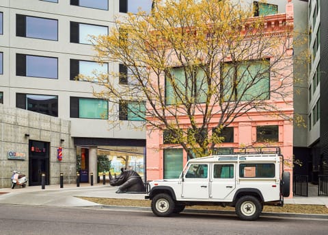 Urban retreat blending modern architecture with historic charm, surrounded by vibrant city energy.