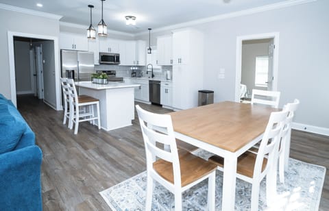 Dining area with seating for four beside the open kitchen