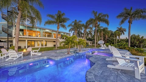 Step into serenity as you dip into your private waterfront pool—palm trees swaying, spa bubbles rising, and the waterway sparkling just beyond.