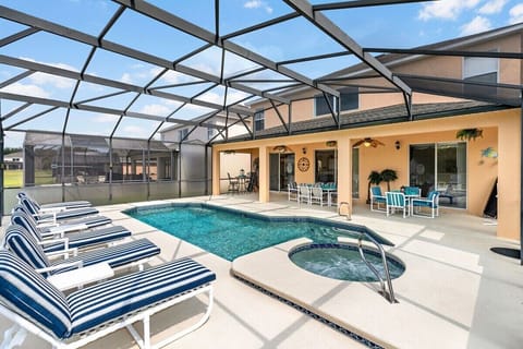 Large private pool with spa, privacy screens, covered lanai with 2 ceiling fans and 2 tables, lake and conservation views