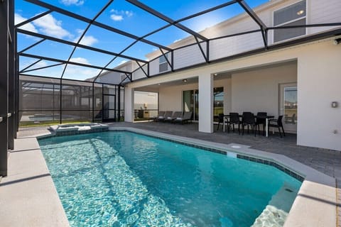 Large swimming pool with spa and covered outdoor dining area