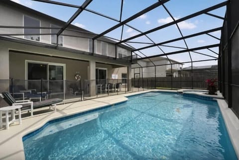 A beautiful south-facing pool with a dining area and sun loungers creates an inviting and luxurious outdoor space, perfect for entertaining.