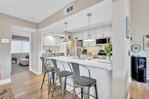 To your left from the entrance, a large, fully-equipped kitchen awaits, simplifying meal preparation.