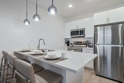 Unleash your inner chef in this stylish, fully equipped kitchen with top-notch appliances - Inviting island bar for coffee, snacks, or lively conversations - From meal prep to midnight snacks, this modern space makes every moment enjoyable