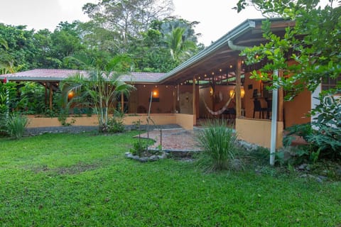 Open outdoor terrace, garden views, and covered dining area surrounded by tropical greenery in Playa Chiquita, Casa Rakú