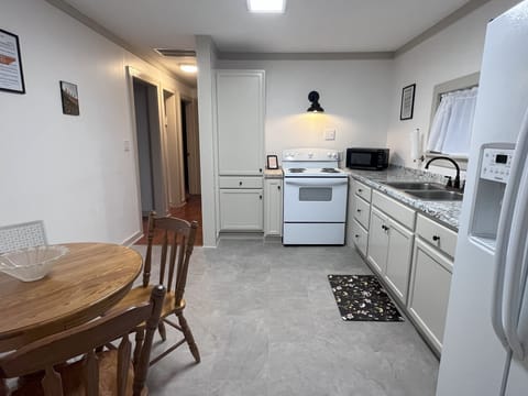 The kitchen is stocked with a toaster, a coffee maker, pots and cooking utensils