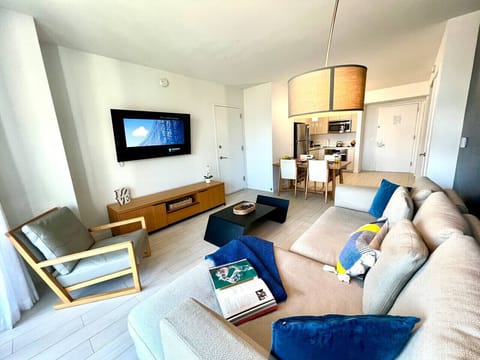 Comfortable lounge space with Smart TV and clean design.