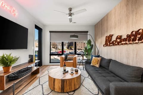 Floor-to-ceiling windows flood the living room with natural light and city views.