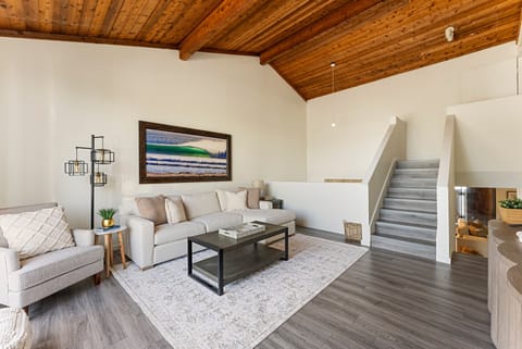 Upstairs lounge area featuring a smart TV, with stairs leading to the master bedroom.