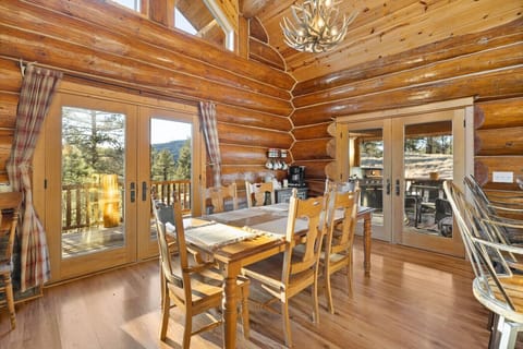 The dining area offers a comfortable space to enjoy meals, with easy access to the deck for outdoor relaxation.