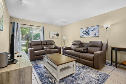 Comfortable living room with reclining couches- perfect for relaxing after a long day