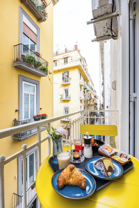 Deluxe Triple Room, Balcony, City View | In-room dining