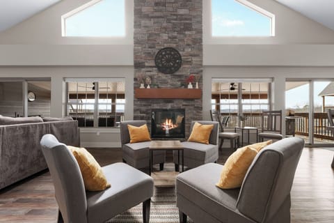 - Gather around the stunning stone fireplace for warm conversation & cozy vibes
- With soaring ceilings & natural light pouring in, this space feels both grand & welcoming
- Perfect spot for morning coffee, evening wine, or just relaxing fireside