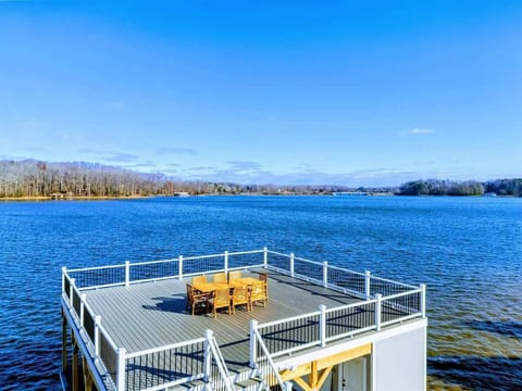 A beautiful two-level dock extends over the lake, complete with a dining area and stunning water views, ideal for relaxation and entertaining.