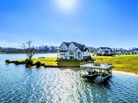 A stunning waterfront property features a spacious home with a private dock and panoramic views of the lake, perfect for relaxation and outdoor enjoyment.