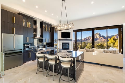 With 5 ensuite bedrooms, a gourmet kitchen, a game room, a private outdoor space featuring a hot tub, putting green, and fire pits, this multi-million-dollar home is perfect for families or groups seeking relaxation and style.