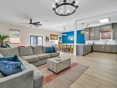 Two Sided Living Area with Sectional Seating, TV's and Festive Artwork