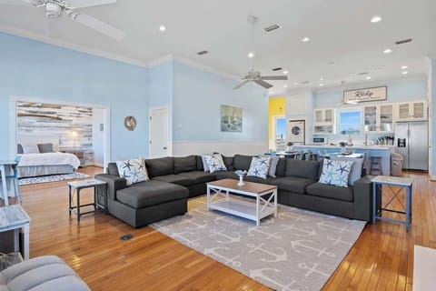 A space where coastal charm meets modern comfort.  From the warm wood floors to the ocean-inspired accents, this living room invites you to relax, recharge, and relish the view #CoastalElegance