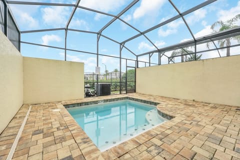 Enjoy a private screened pool area with brick paver decking for relaxing swims.